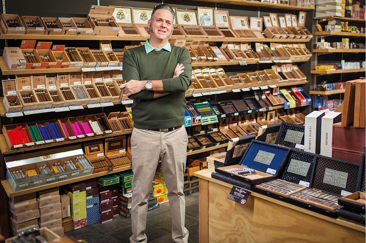 Dion Gioliito standing in front cigar display